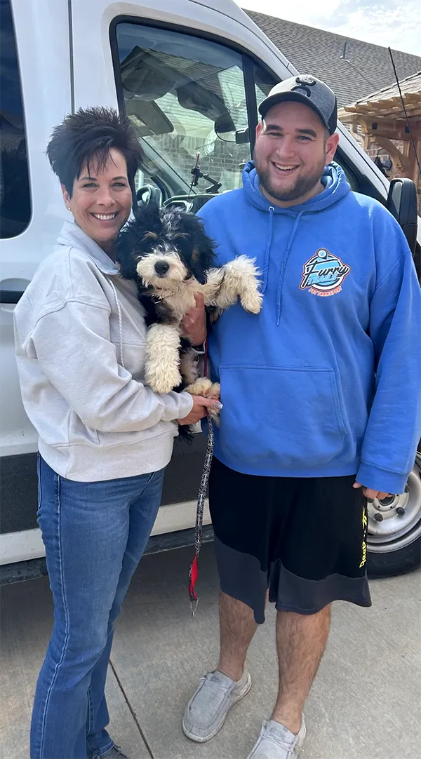 Happy Customer And Mini-Bernedoodle Puppy With Delivery Driver